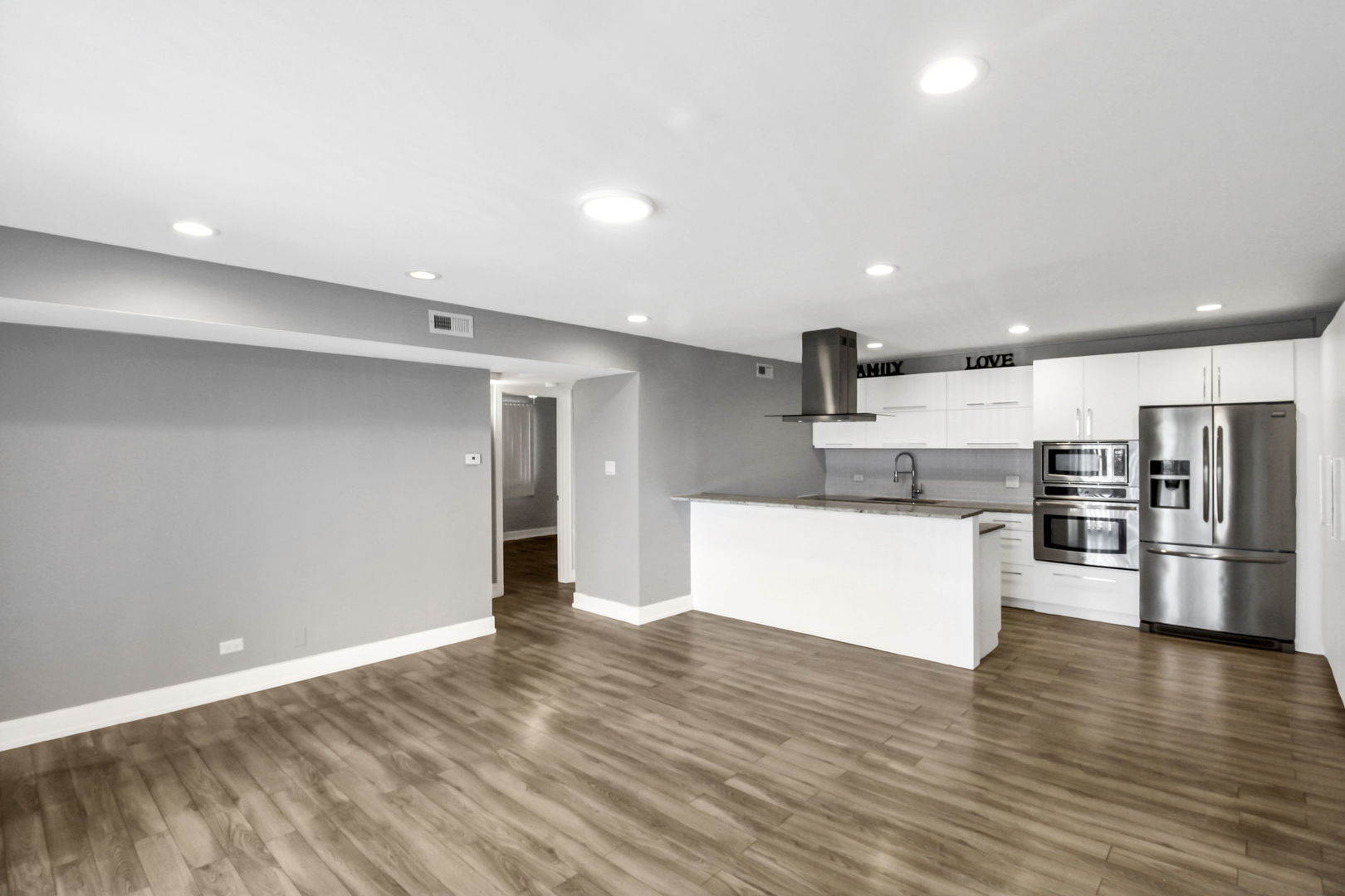 16622 Theresa Lane, Unit 304 Tinley Park, IL 60477 - Photo 6 of 16 a kitchen with stainless steel appliances a refrigerator and white cabinets