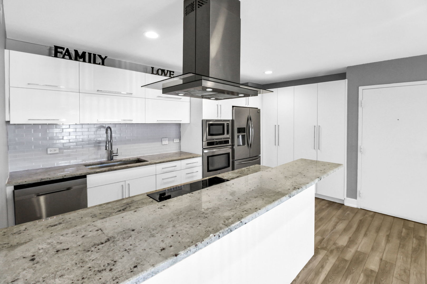 16622 Theresa Lane, Unit 304 Tinley Park, IL 60477 - Photo 10 of 16 a large kitchen with kitchen island a sink stainless steel appliances and cabinets