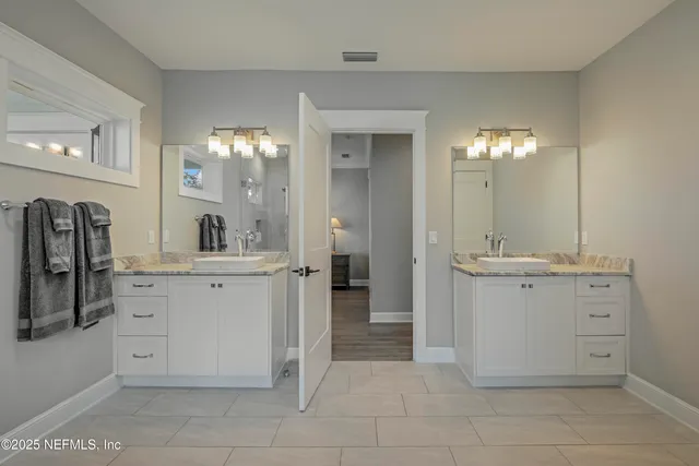 a park bench sitting in the middle of a park with large trees