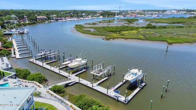 an aerial view of a house with garden space and ocean view