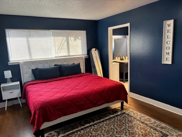 a bed sitting in a bedroom next to a window