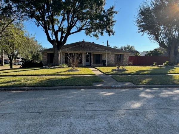 a view of swimming pool with lawn chairs and plants