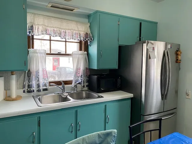 a kitchen with a refrigerator and a sink