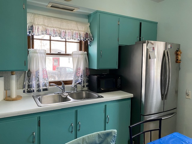 412 West 2nd Street Lostant, IL 61334 - Photo 5 of 22 a kitchen with a refrigerator and a sink