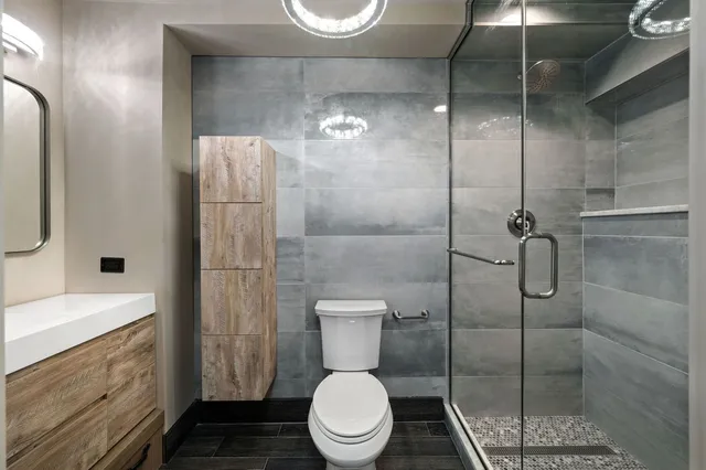 a bathroom with a toilet and a shower