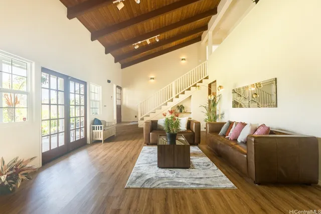 a living room with furniture and wooden floor