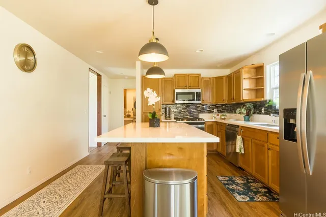 a kitchen with stainless steel appliances granite countertop a sink and a stove