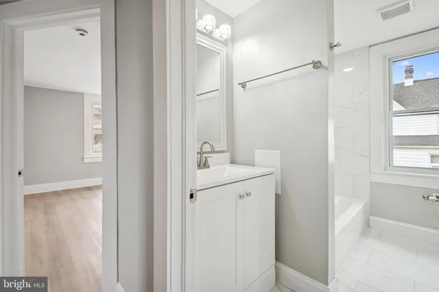 a bathroom with a sink a mirror and a shower