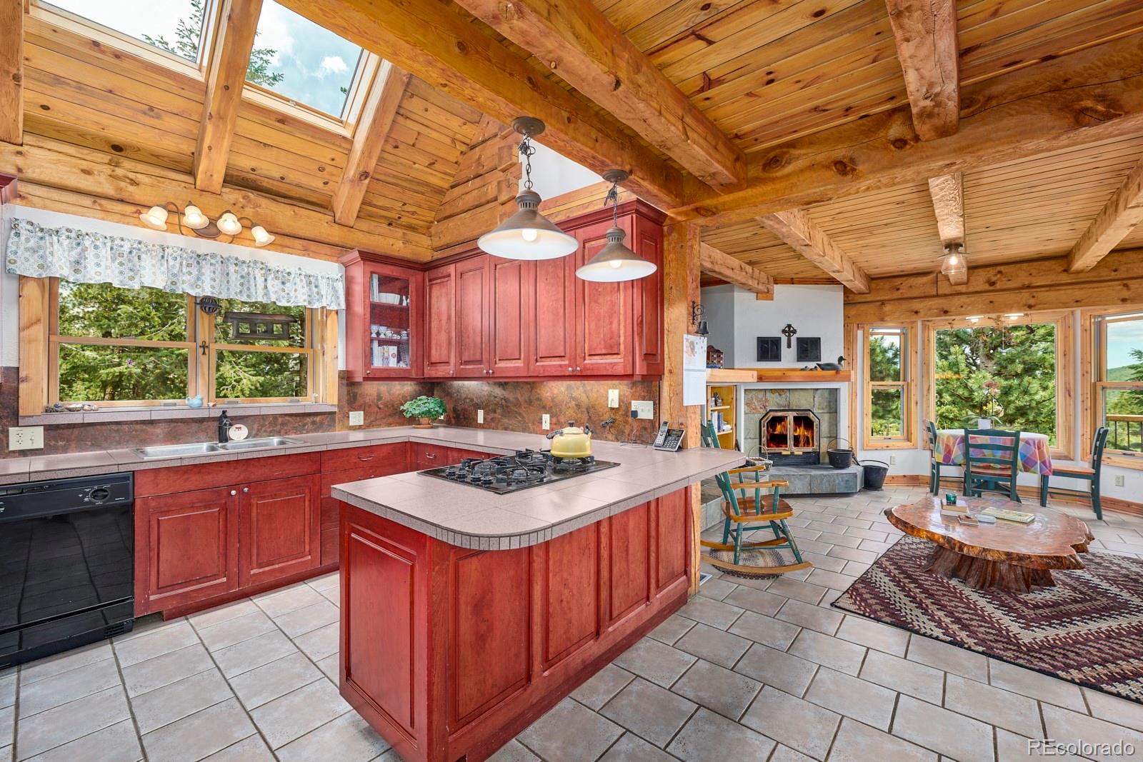 2847 Ridge Road Nederland, CO 80466 - Photo 11 of 40 a kitchen with a stove sink and cabinets