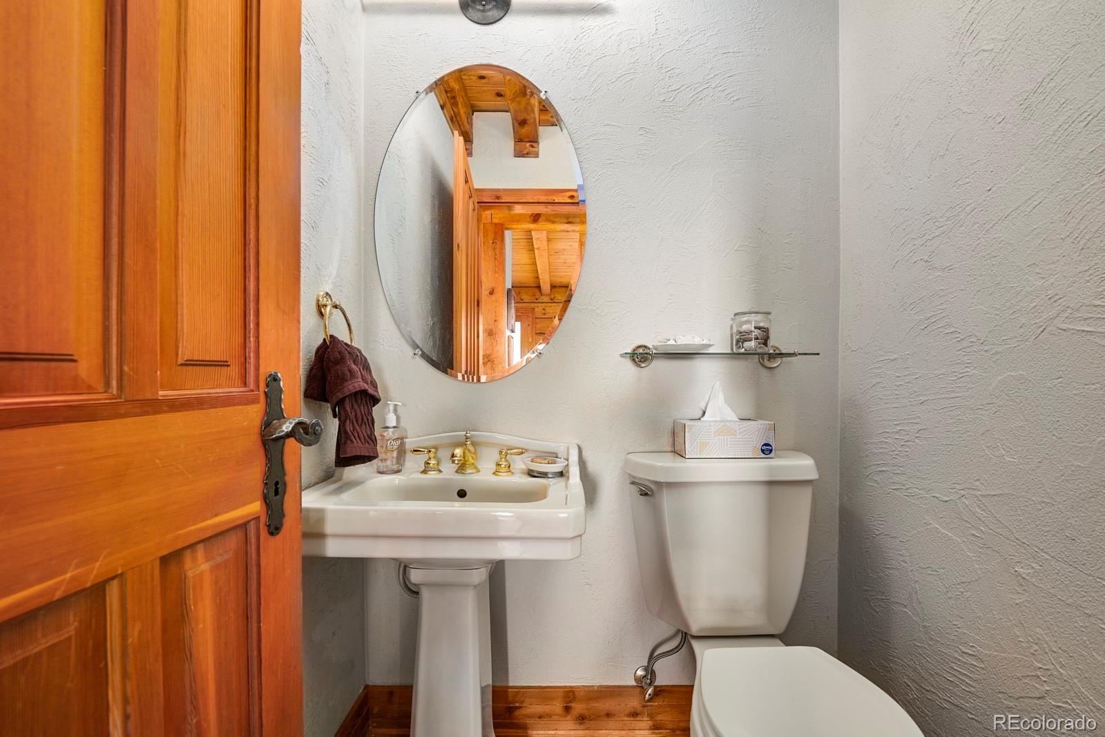 2847 Ridge Road Nederland, CO 80466 - Photo 15 of 40 a bathroom with a toilet a sink and a mirror