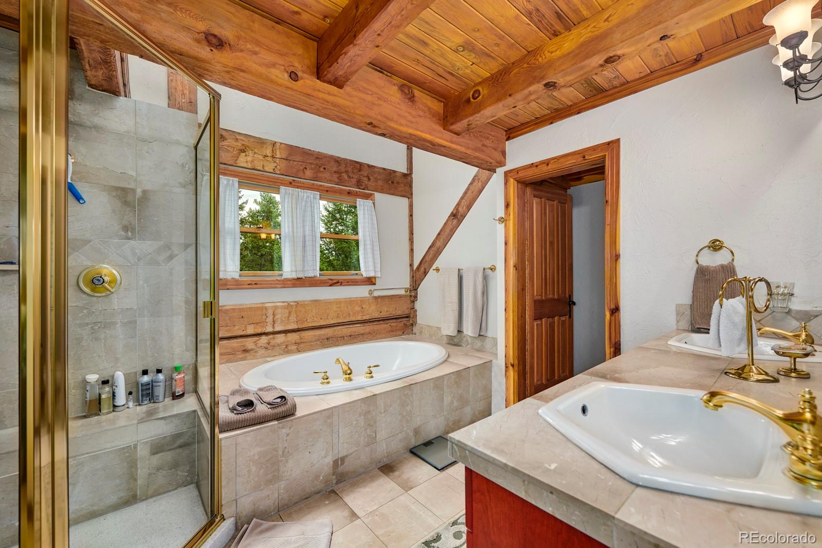 2847 Ridge Road Nederland, CO 80466 - Photo 20 of 40 a bathroom with a tub sink and mirror