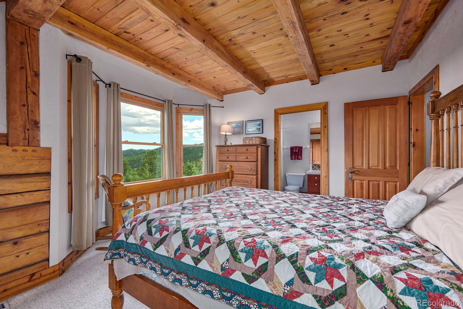 2847 Ridge Road Nederland, CO 80466 - Photo 21 of 40 a bed sitting in a bedroom next to a window