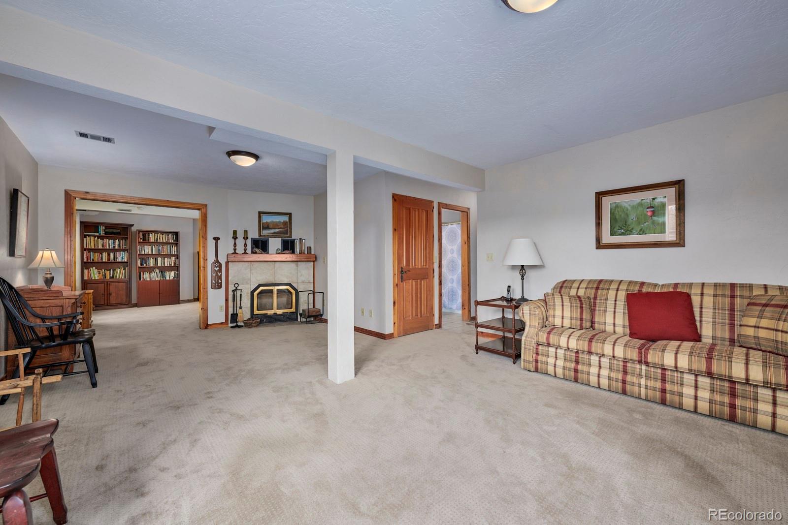 2847 Ridge Road Nederland, CO 80466 - Photo 28 of 40 a living room with furniture and a book shelf