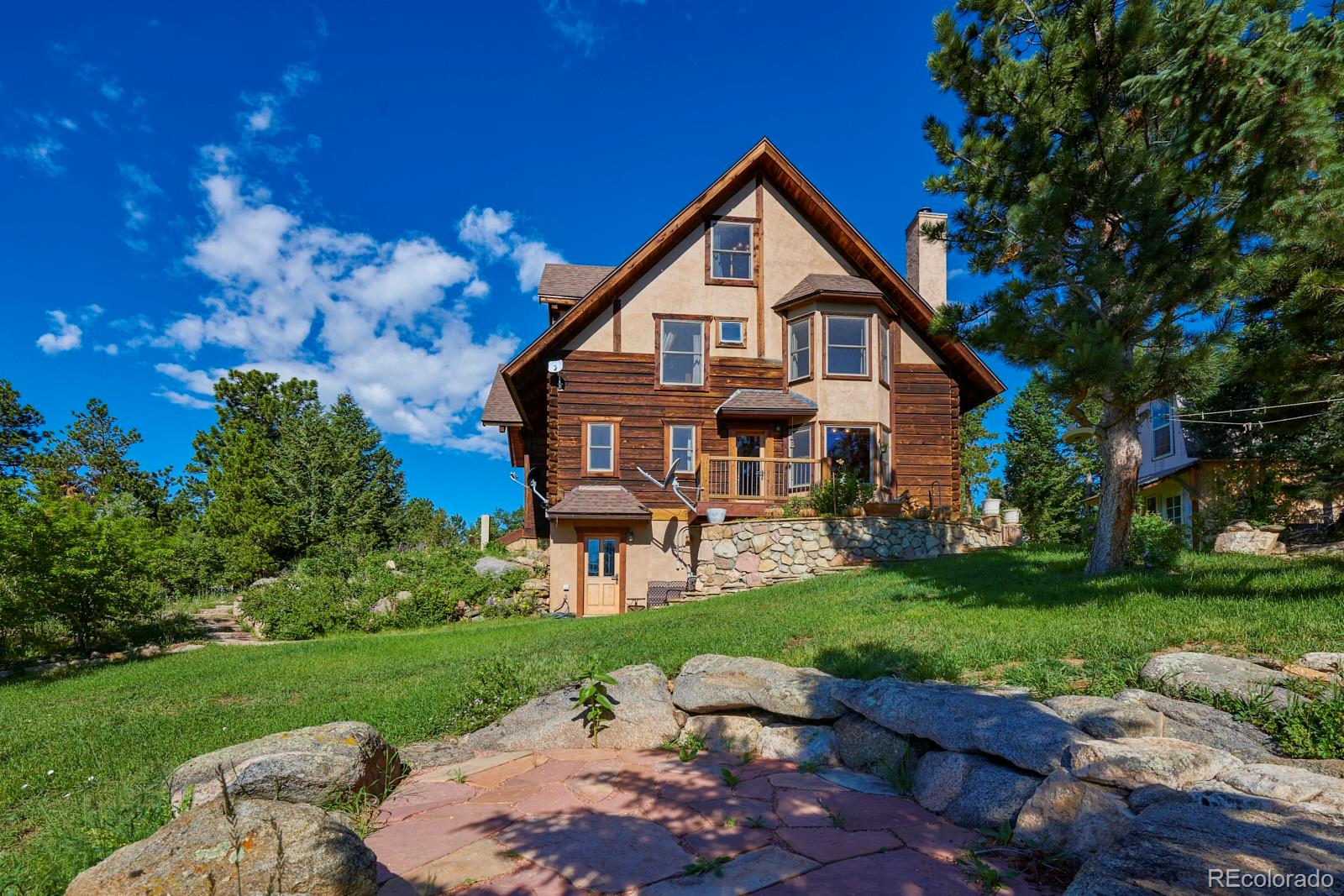 2847 Ridge Road Nederland, CO 80466 - Photo 32 of 40 a front view of a house with garden