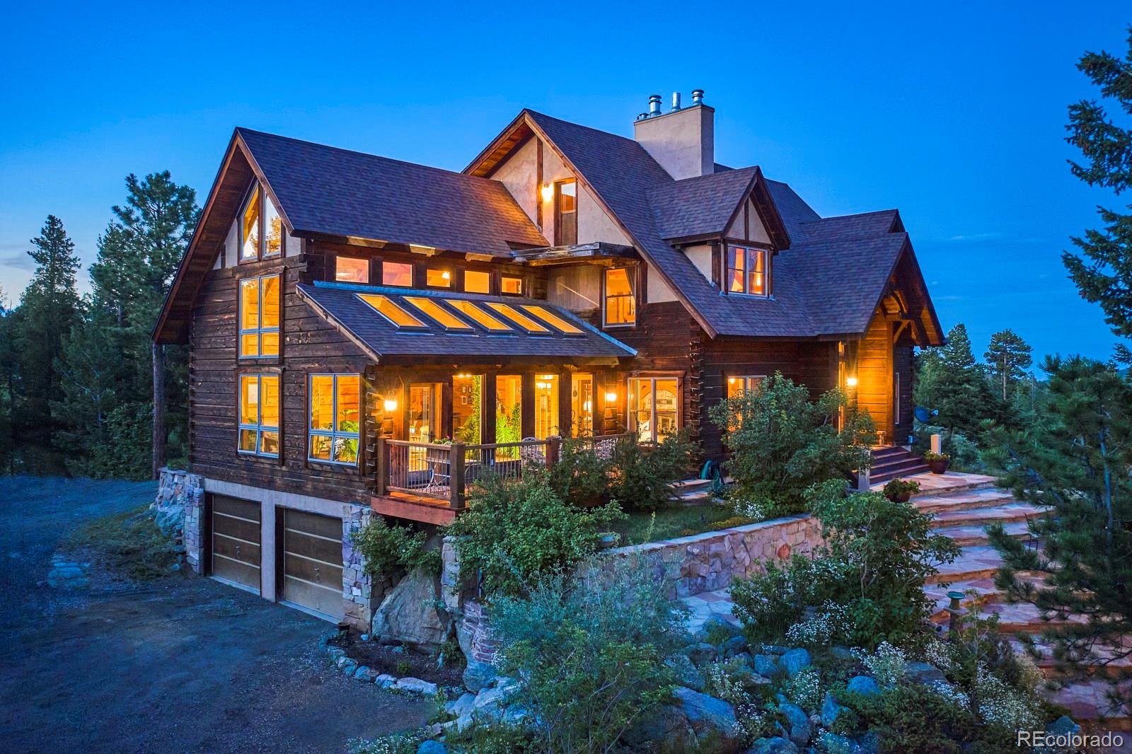 2847 Ridge Road Nederland, CO 80466 - Photo 33 of 40 a view of a cafe with a yard and table and chairs under an umbrella