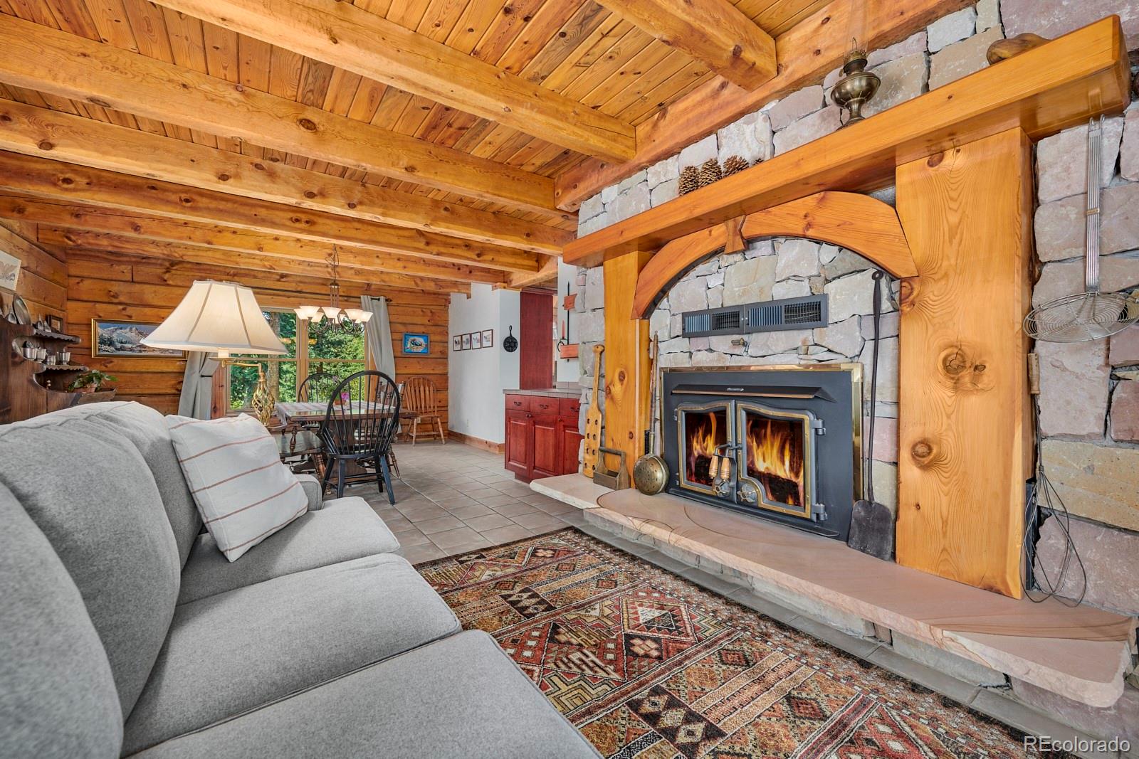 2847 Ridge Road Nederland, CO 80466 - Photo 6 of 40 a living room with furniture and a fireplace