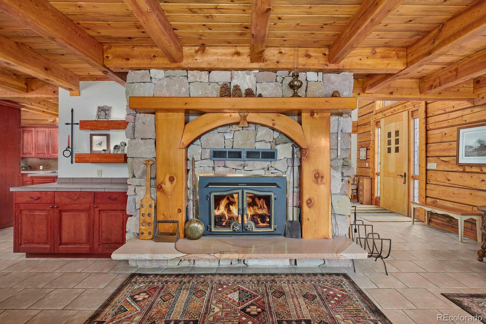 2847 Ridge Road Nederland, CO 80466 - Photo 7 of 40 a living room with stainless steel appliances wooden floors and fireplace