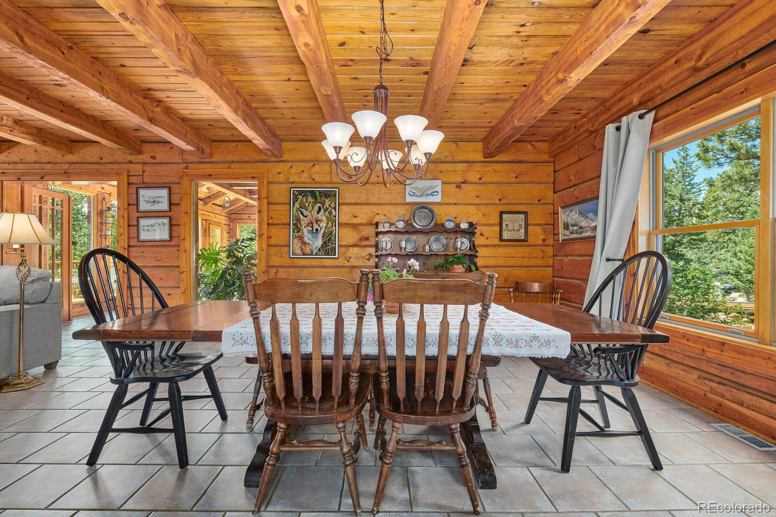 2847 Ridge Road Nederland, CO 80466 - Photo 8 of 40 a view of a dining room with furniture a chandelier and wooden floor