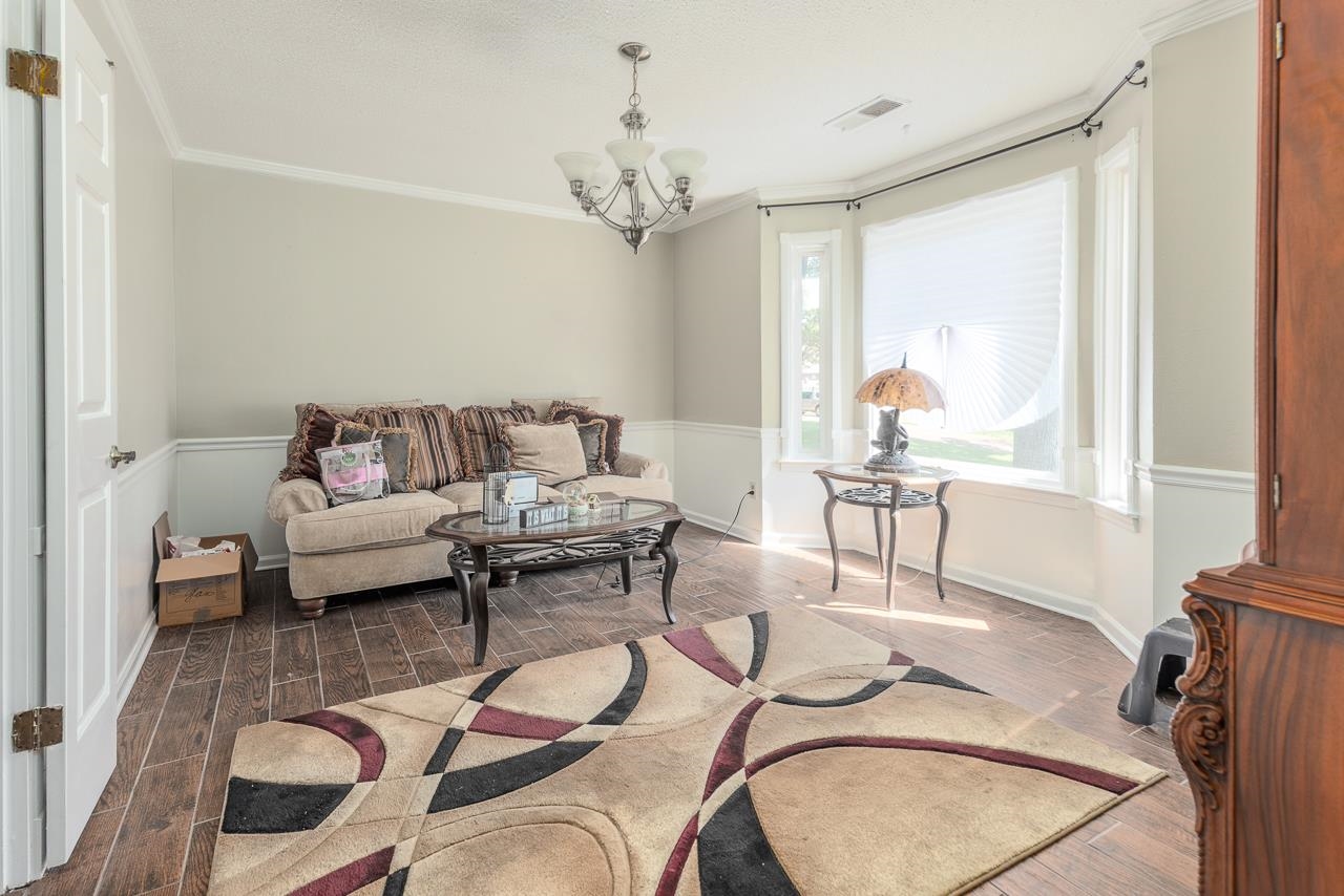 7829 Gateway Inlet Memphis, TN 38119 - Photo 11 of 30 a living room with furniture and a chandelier