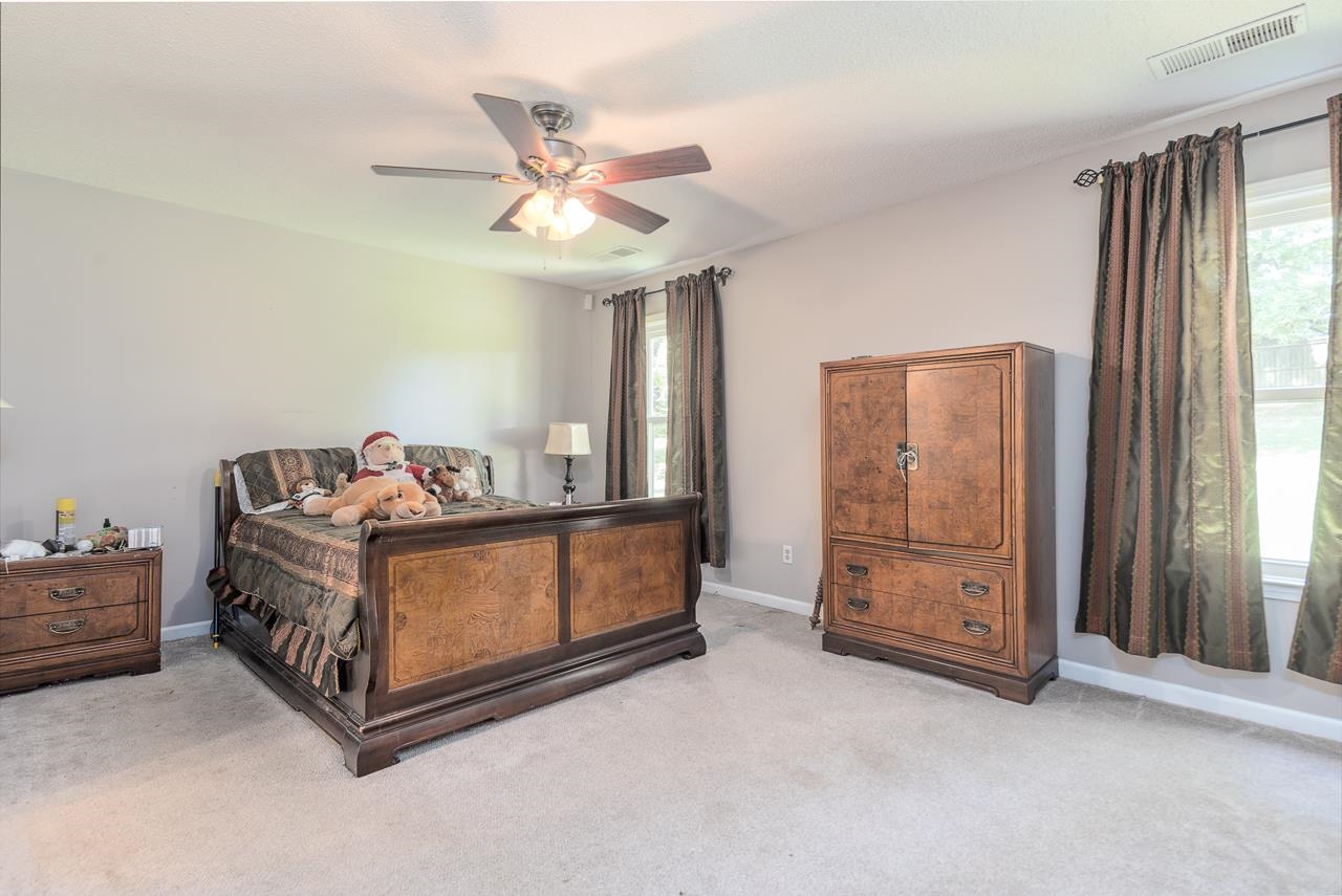 7829 Gateway Inlet Memphis, TN 38119 - Photo 2 of 30 a bed room with a bed and a ceiling fan