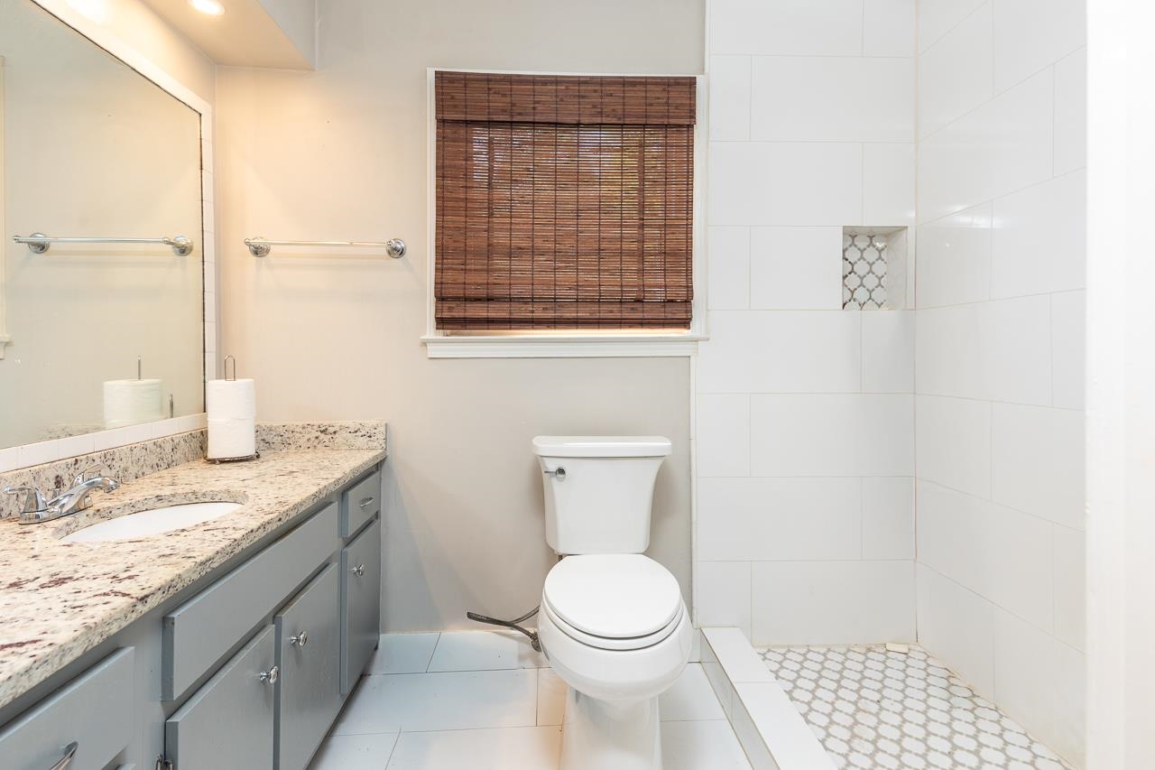 7829 Gateway Inlet Memphis, TN 38119 - Photo 4 of 30 a bathroom with a granite countertop sink a toilet and a shower