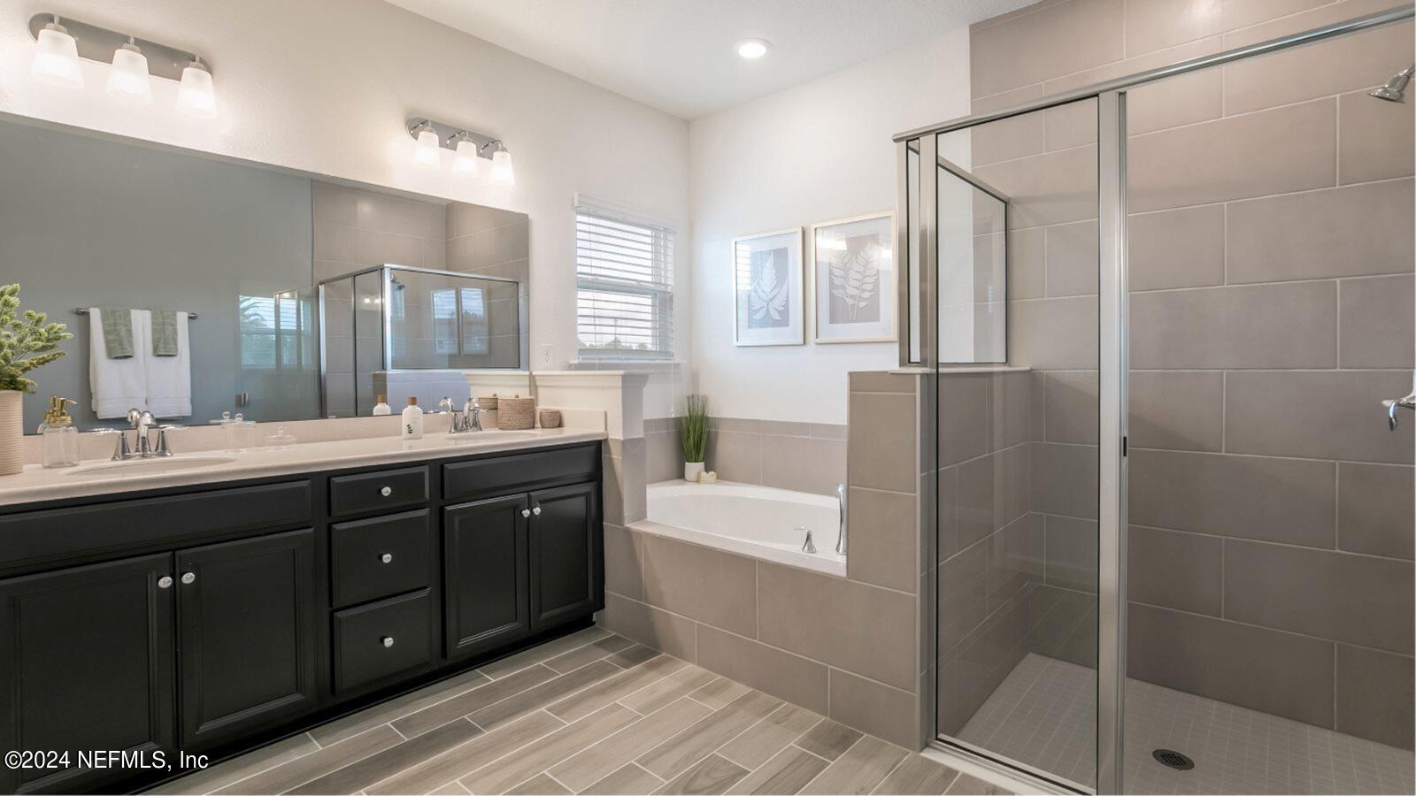 59 Bevins Lane St. Augustine, FL 32092 - Photo 11 of 14 a bathroom with a double vanity sink a large mirror and shower