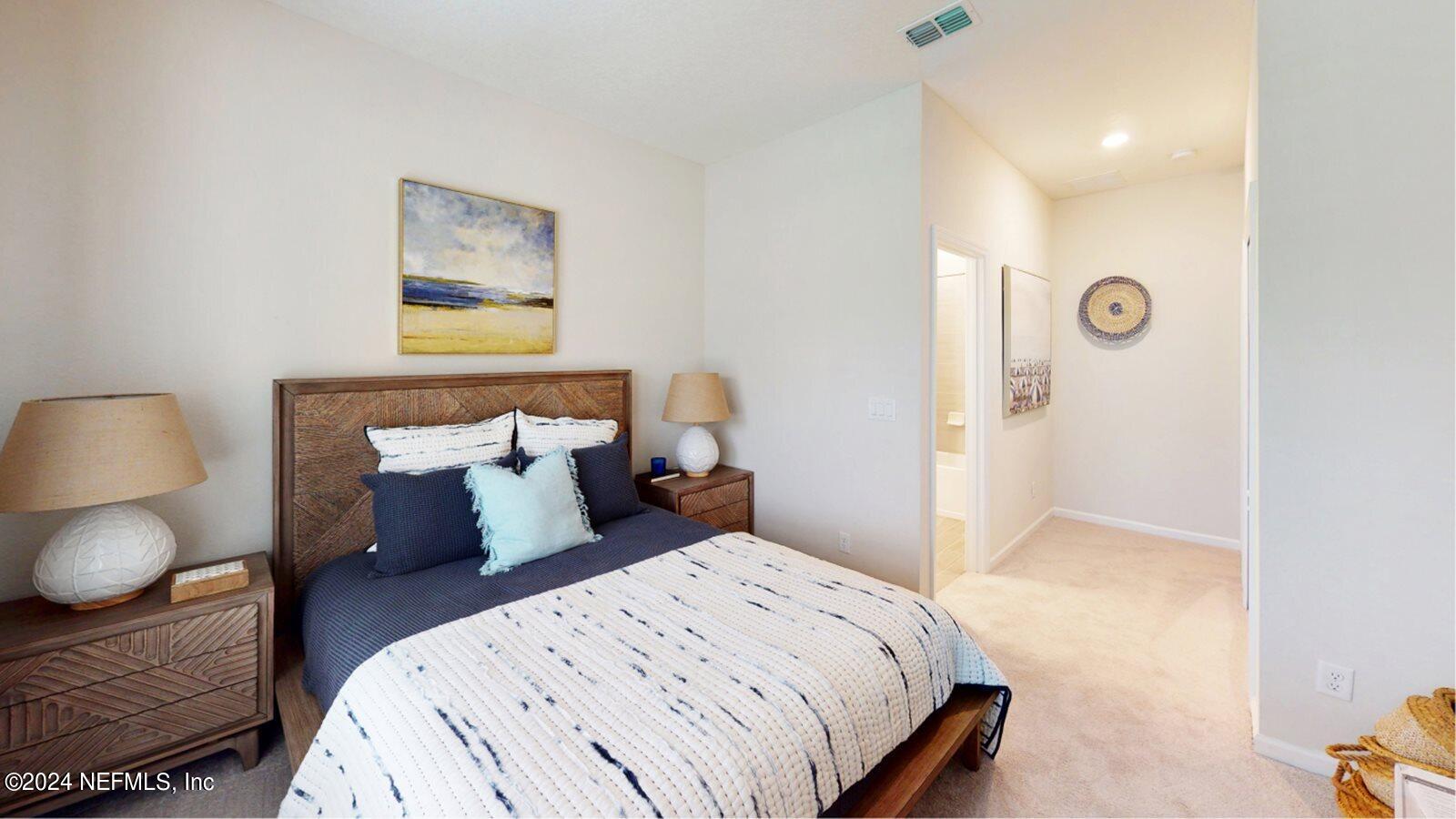 59 Bevins Lane St. Augustine, FL 32092 - Photo 2 of 14 a bedroom with a bed and a painting on the wall