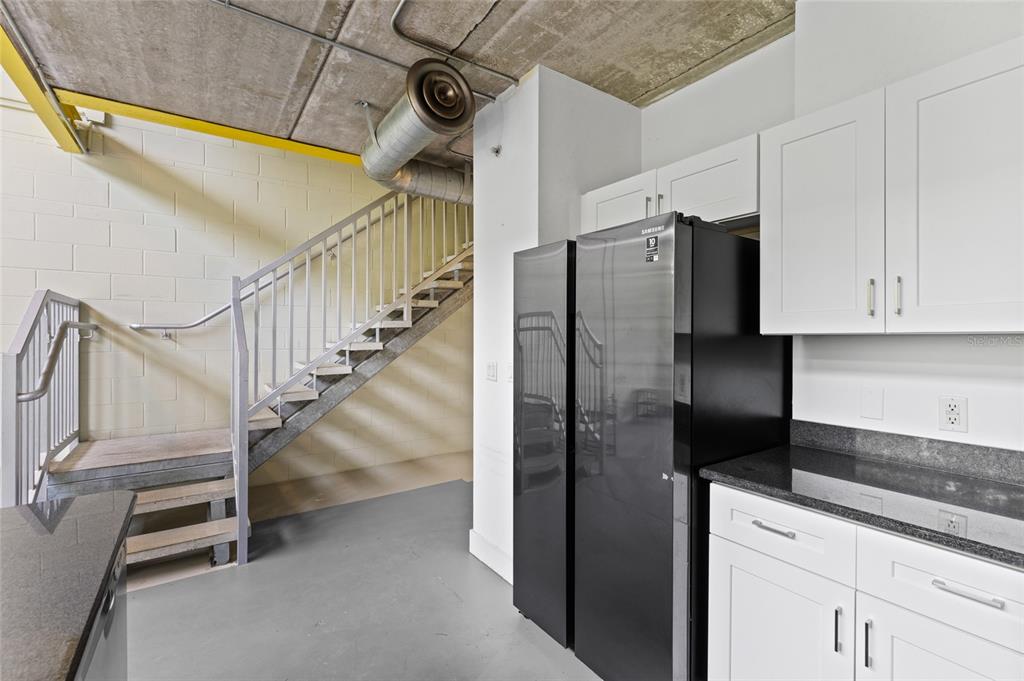 2515 Southwest 35th Place, Unit 203 Gainesville, FL 32608 - Photo 13 of 22 a kitchen with cabinets and stainless steel appliances