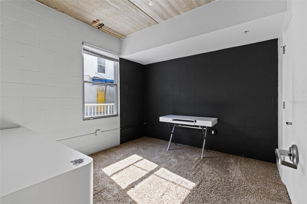 2515 Southwest 35th Place, Unit 203 Gainesville, FL 32608 - Photo 14 of 22 a room with a window and a table