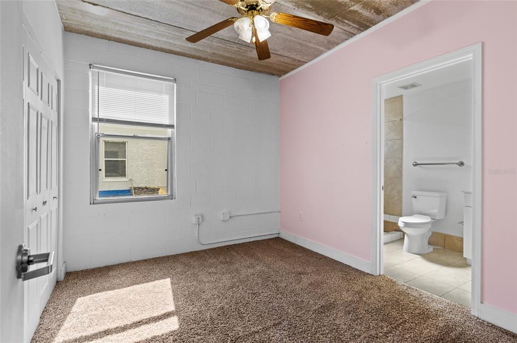 2515 Southwest 35th Place, Unit 203 Gainesville, FL 32608 - Photo 15 of 22 a view of a bathroom with a toilet sink and a mirror