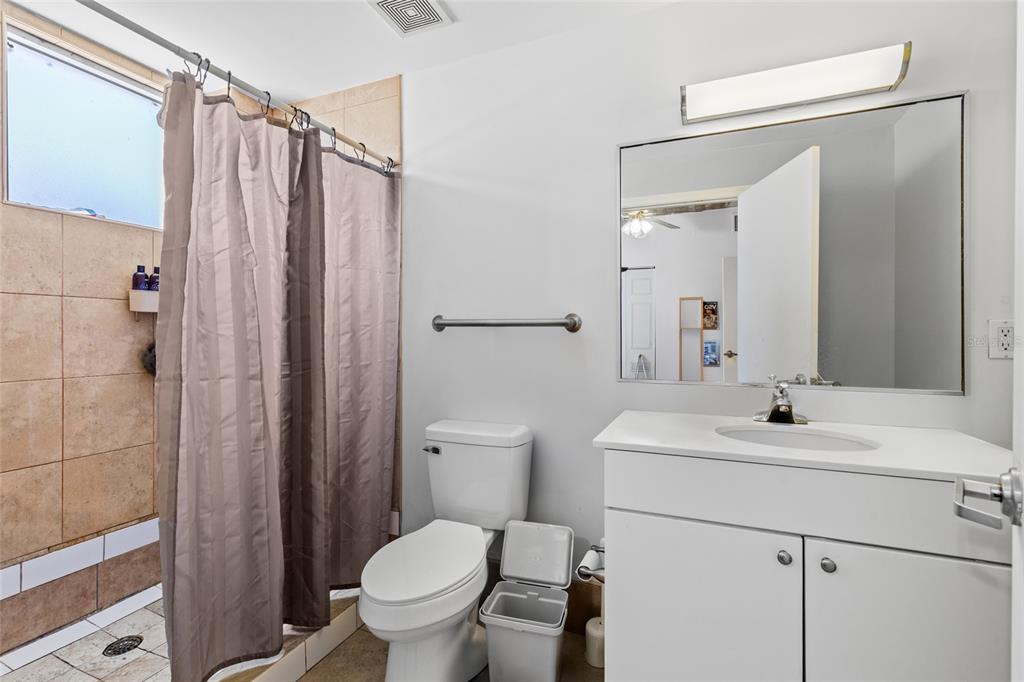 2515 Southwest 35th Place, Unit 203 Gainesville, FL 32608 - Photo 16 of 22 a bathroom with a sink toilet and shower