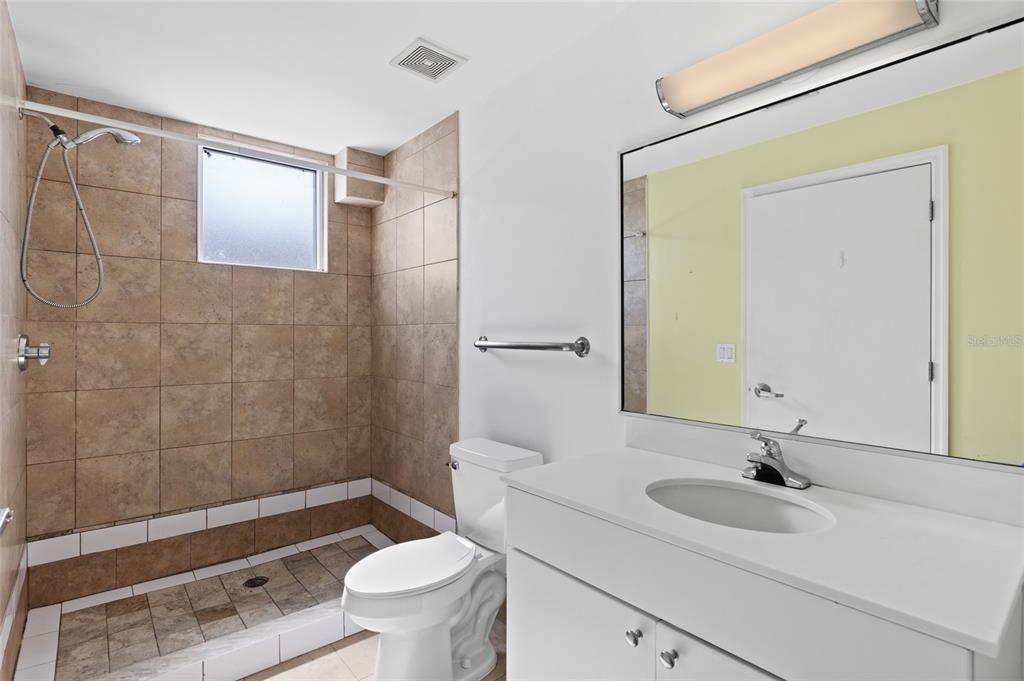 2515 Southwest 35th Place, Unit 203 Gainesville, FL 32608 - Photo 17 of 22 a bathroom with a sink a toilet and shower