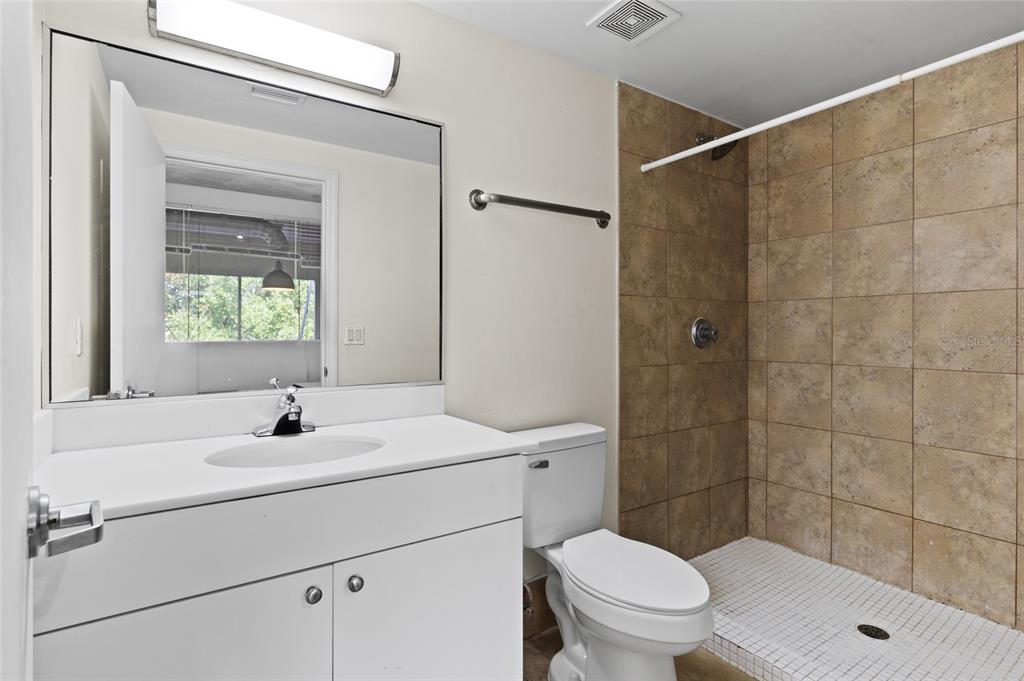 2515 Southwest 35th Place, Unit 203 Gainesville, FL 32608 - Photo 19 of 22 a bathroom with a sink a toilet and shower