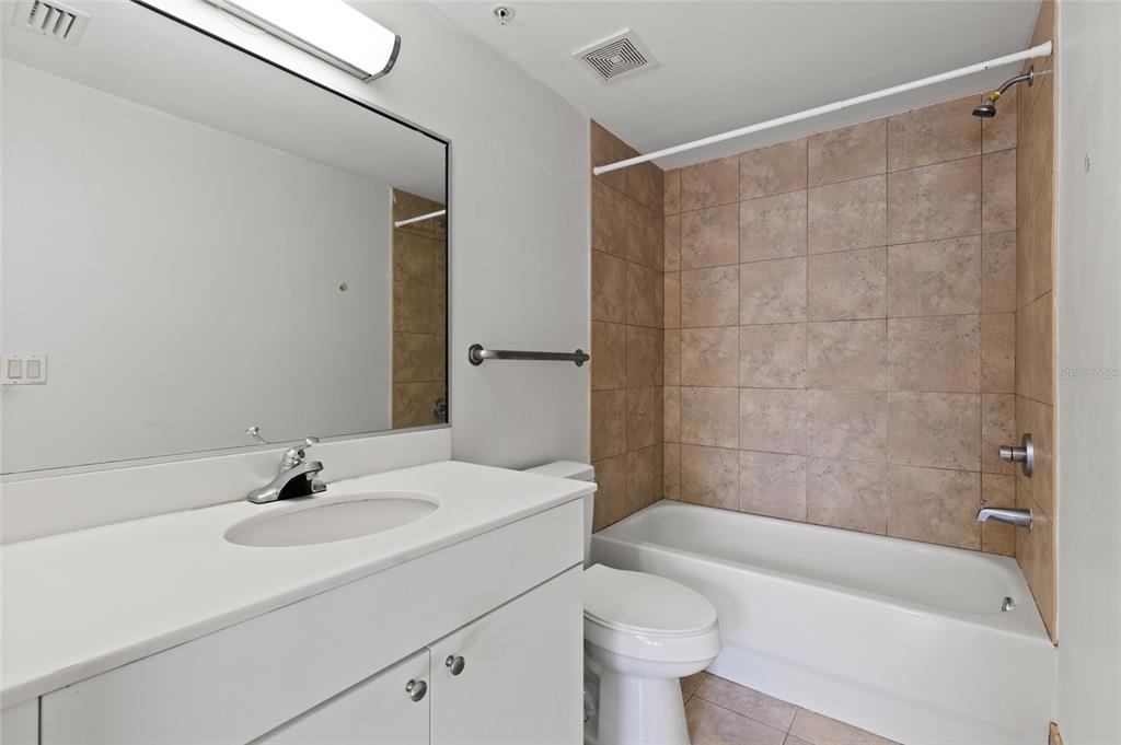 2515 Southwest 35th Place, Unit 203 Gainesville, FL 32608 - Photo 21 of 22 a bathroom with a sink a toilet and shower