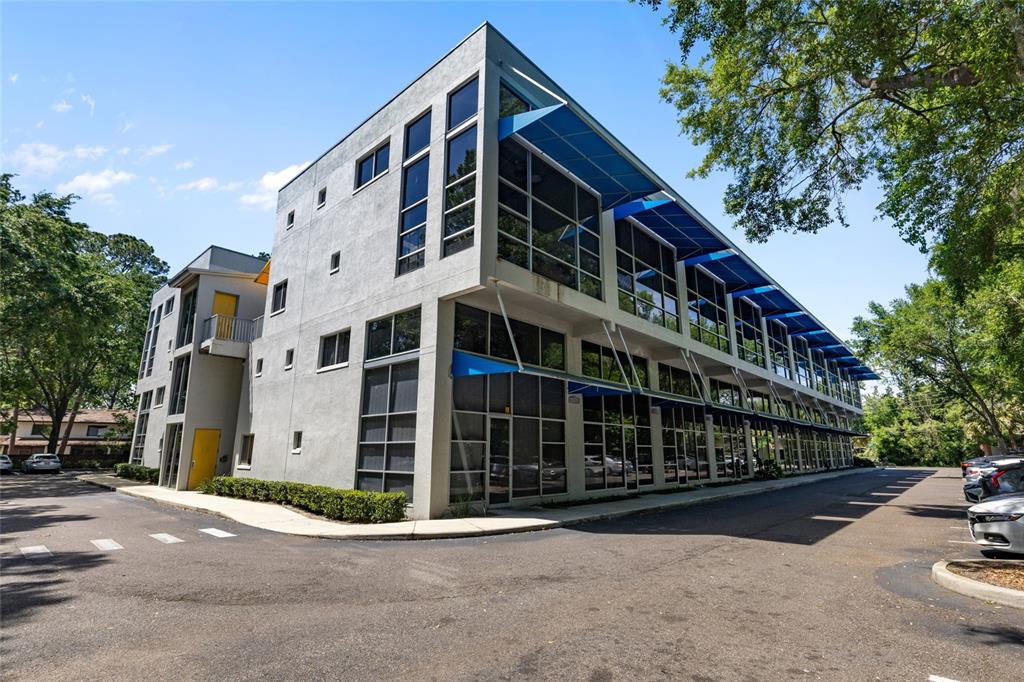 2515 Southwest 35th Place, Unit 203 Gainesville, FL 32608 - Photo 3 of 22 a front view of a building with parking space and trees