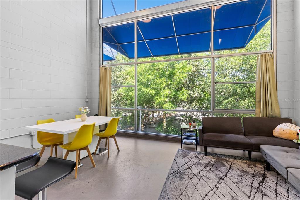 2515 Southwest 35th Place, Unit 203 Gainesville, FL 32608 - Photo 6 of 22 a view of a dining room with furniture and window