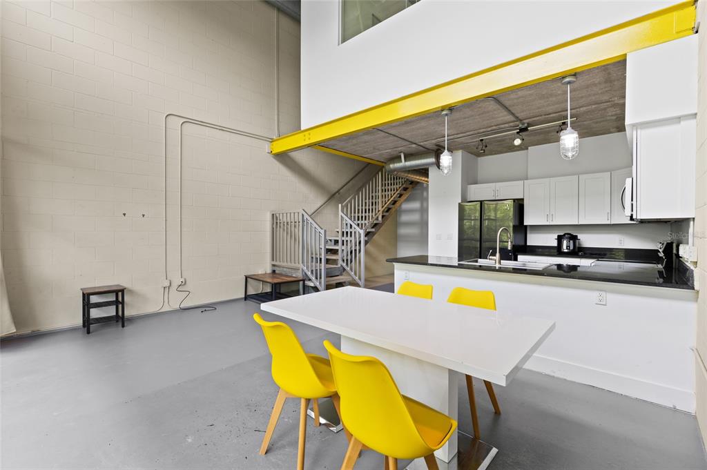 2515 Southwest 35th Place, Unit 203 Gainesville, FL 32608 - Photo 8 of 22 a view of a kitchen with a table and chairs