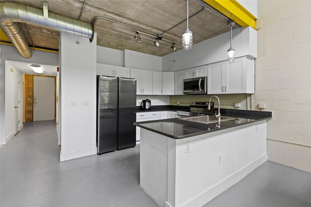 2515 Southwest 35th Place, Unit 203 Gainesville, FL 32608 - Photo 10 of 22 a kitchen with stainless steel appliances a sink and a refrigerator