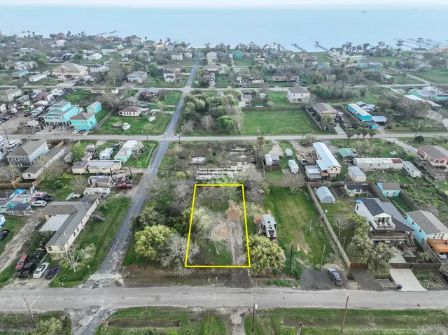 an aerial view of residential houses with outdoor space and street view
