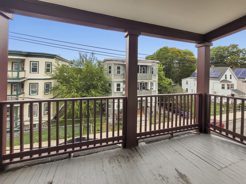 108 Callender Street, Unit 3 Boston, MA 02124 - Photo 11 of 12 a view of a balcony with floor to ceiling windows with wooden floor