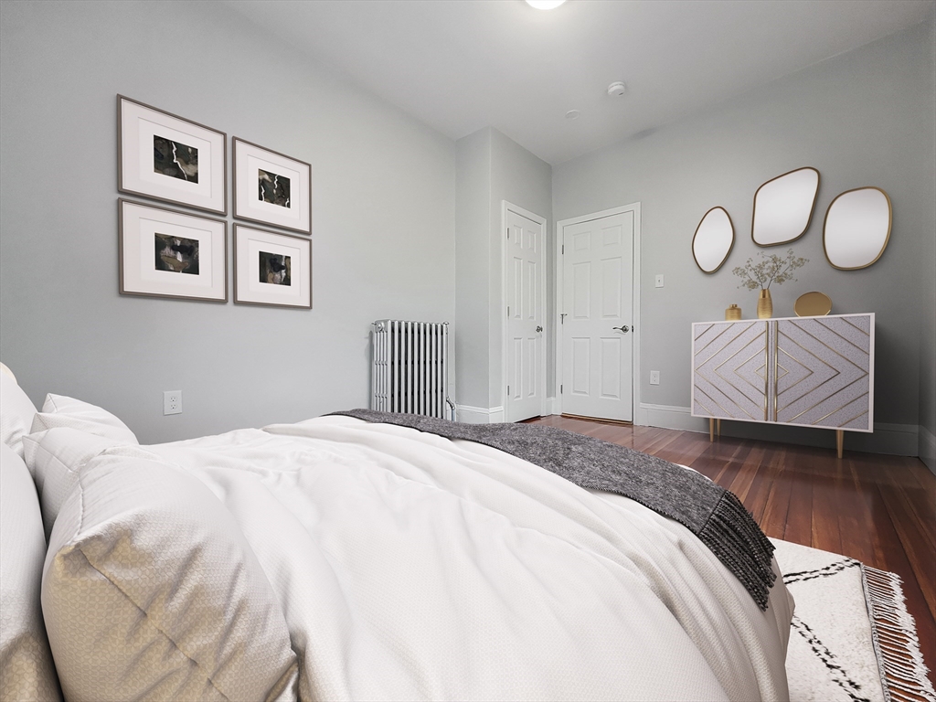 108 Callender Street, Unit 3 Boston, MA 02124 - Photo 4 of 12 a bedroom with bed and night stand