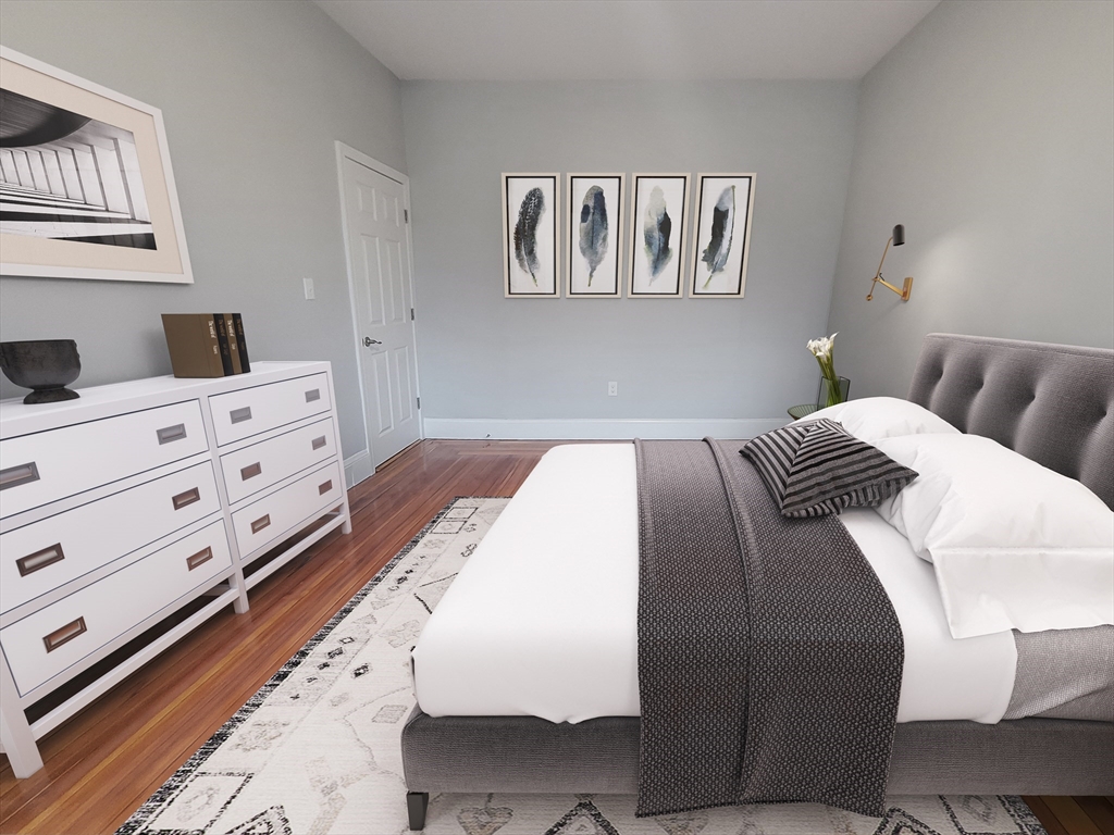 108 Callender Street, Unit 3 Boston, MA 02124 - Photo 5 of 12 a bedroom with a bed and cabinet