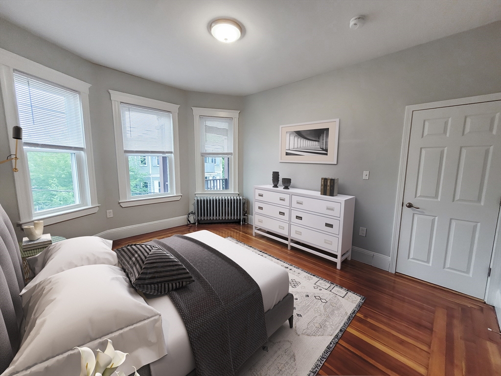 108 Callender Street, Unit 3 Boston, MA 02124 - Photo 6 of 12 a bedroom with a large bed and a window