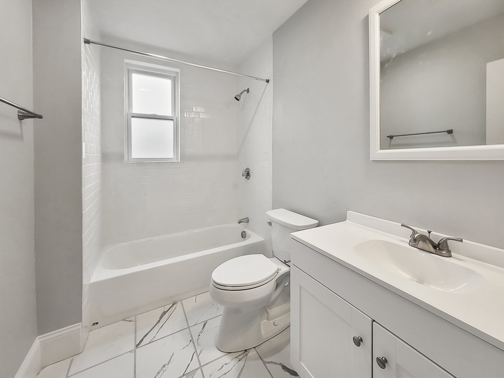 108 Callender Street, Unit 3 Boston, MA 02124 - Photo 10 of 12 a bathroom with a sink a toilet and a mirror