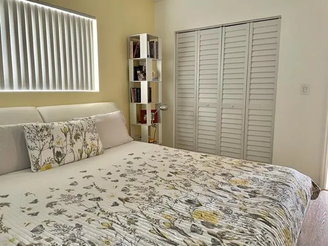 a bedroom with a bed and dresser