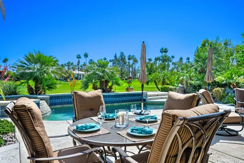 a view of a patio with table and chairs and potted plants