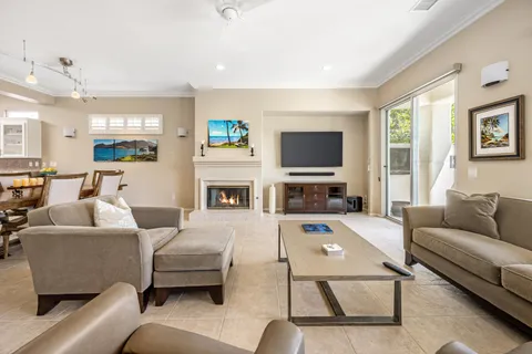 a living room with furniture a flat screen tv and a fireplace