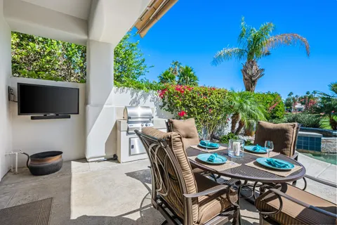 a outdoor dining space with furniture and a potted plant