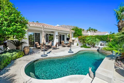 a view of a house with backyard sitting area and garden