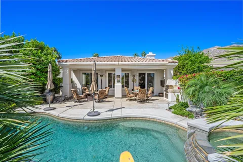 a view of a house with backyard porch and sitting area